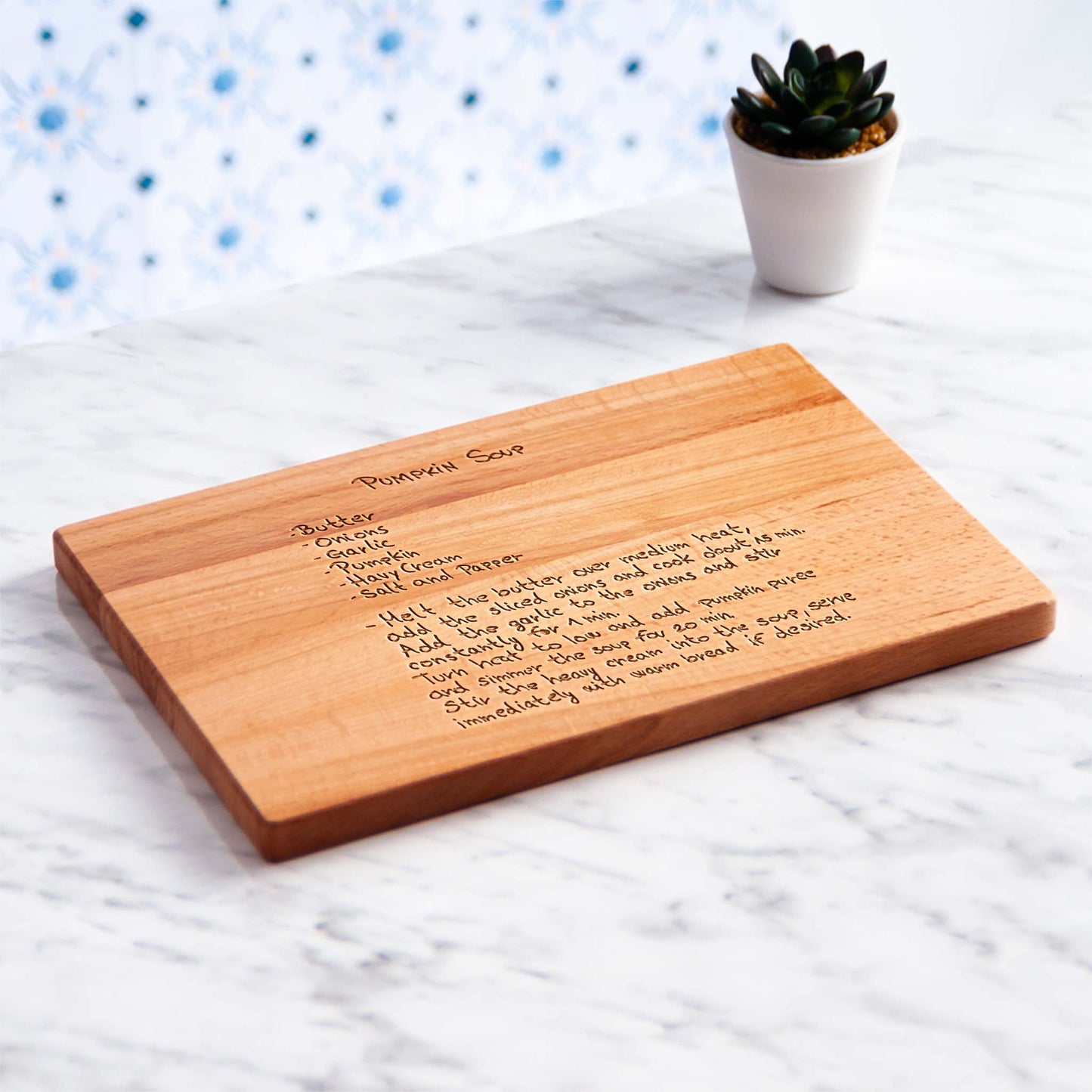 Wooden cutting board with engraved pumpkin soup recipe.