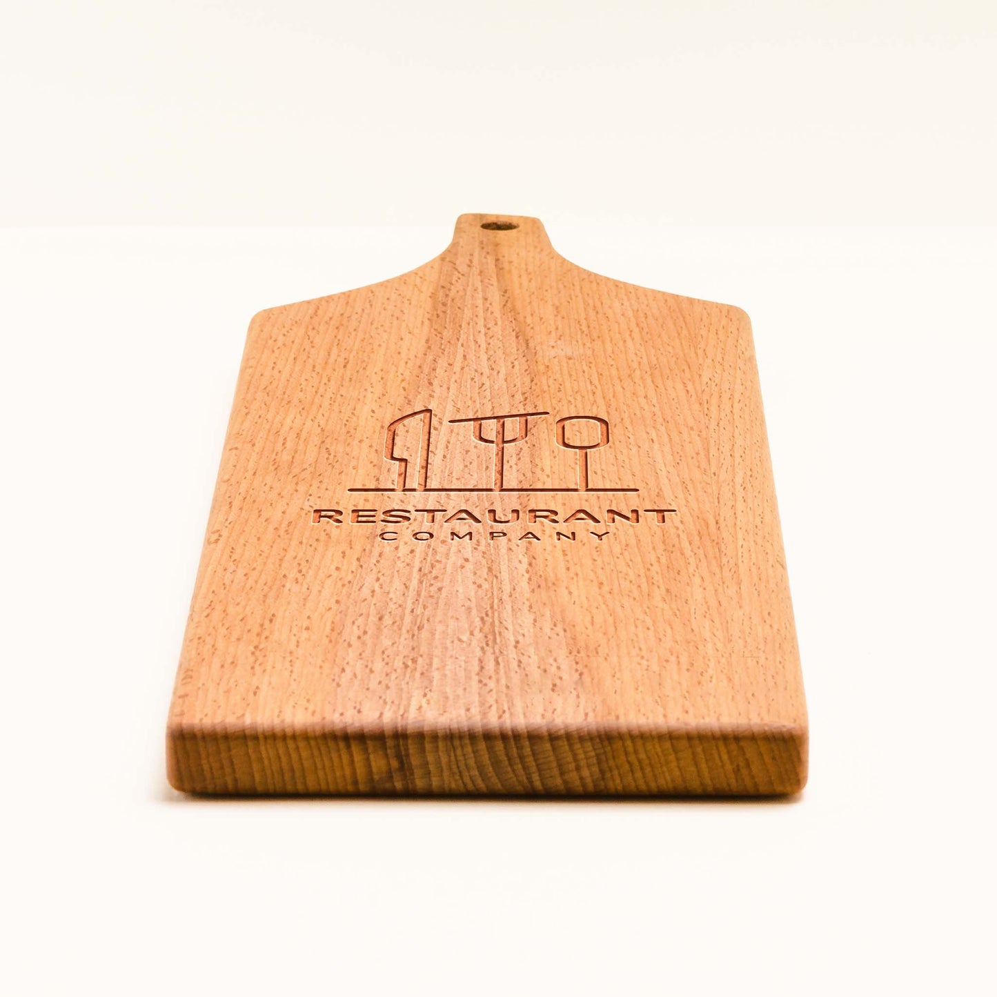 Wooden cutting board with engraved text on a white background