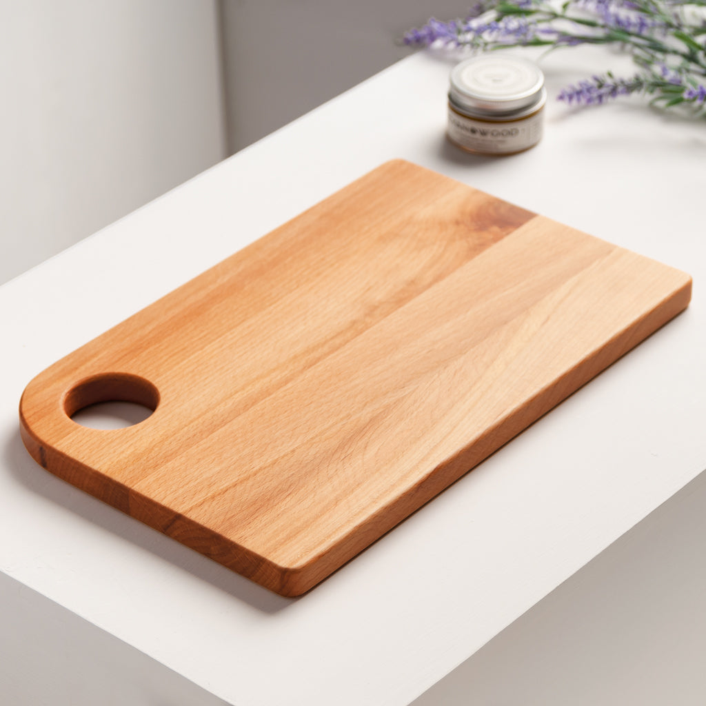 Natural shaped cutting board with handle and a hole for hanging