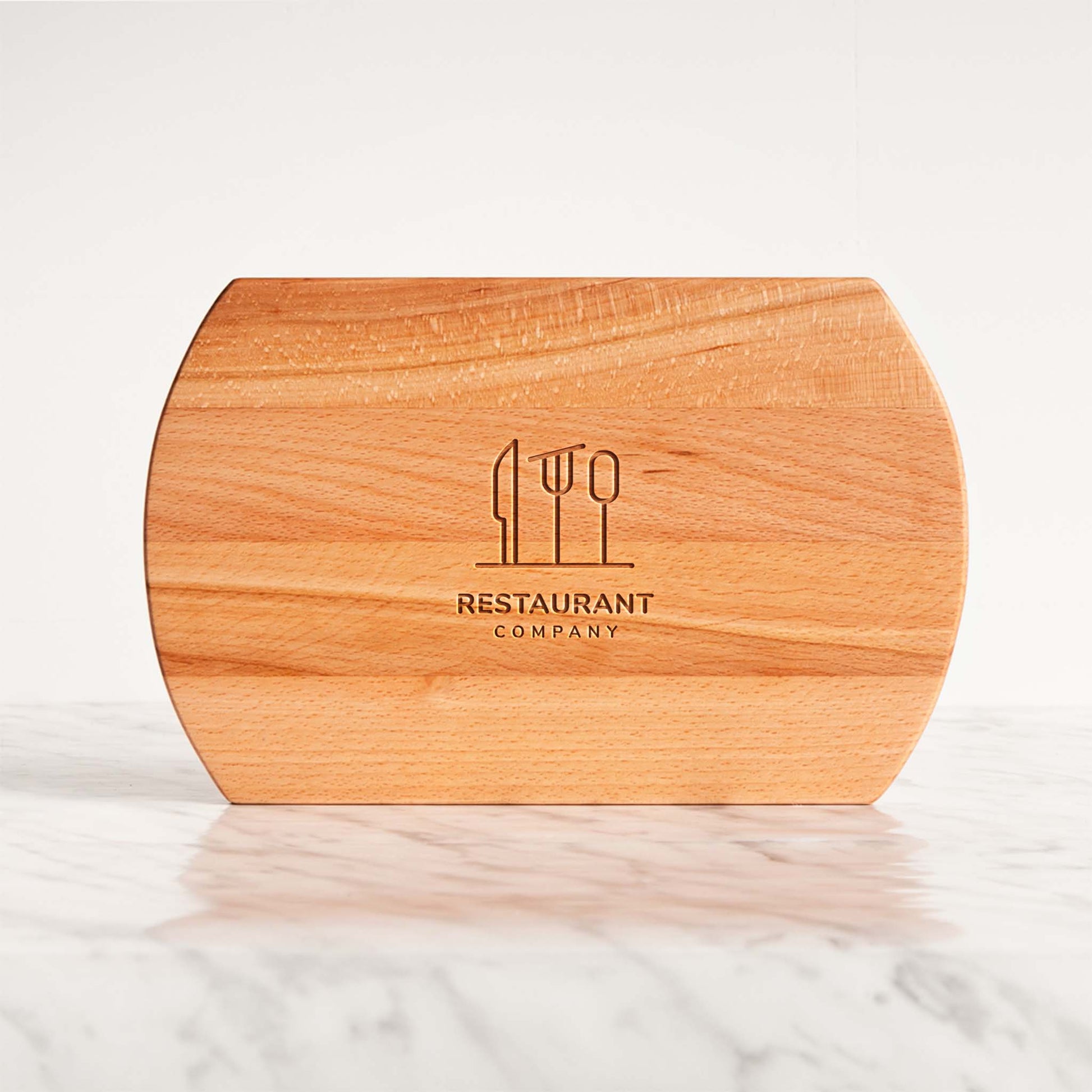 Wooden cutting board with 'Restaurant Company' logo on a marble surface