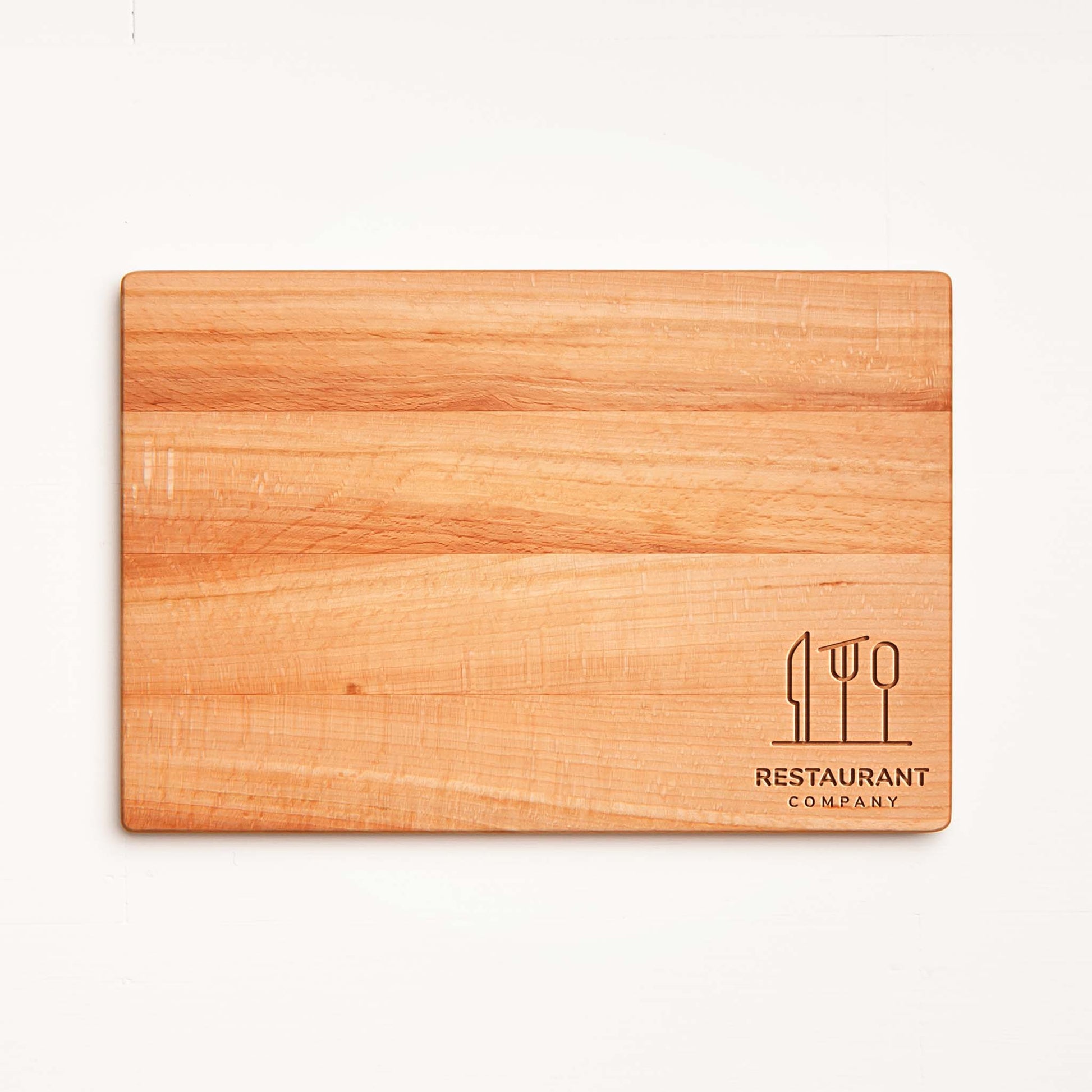 Three sizes of beech cutting boards stacked - hotel and bar branding.
