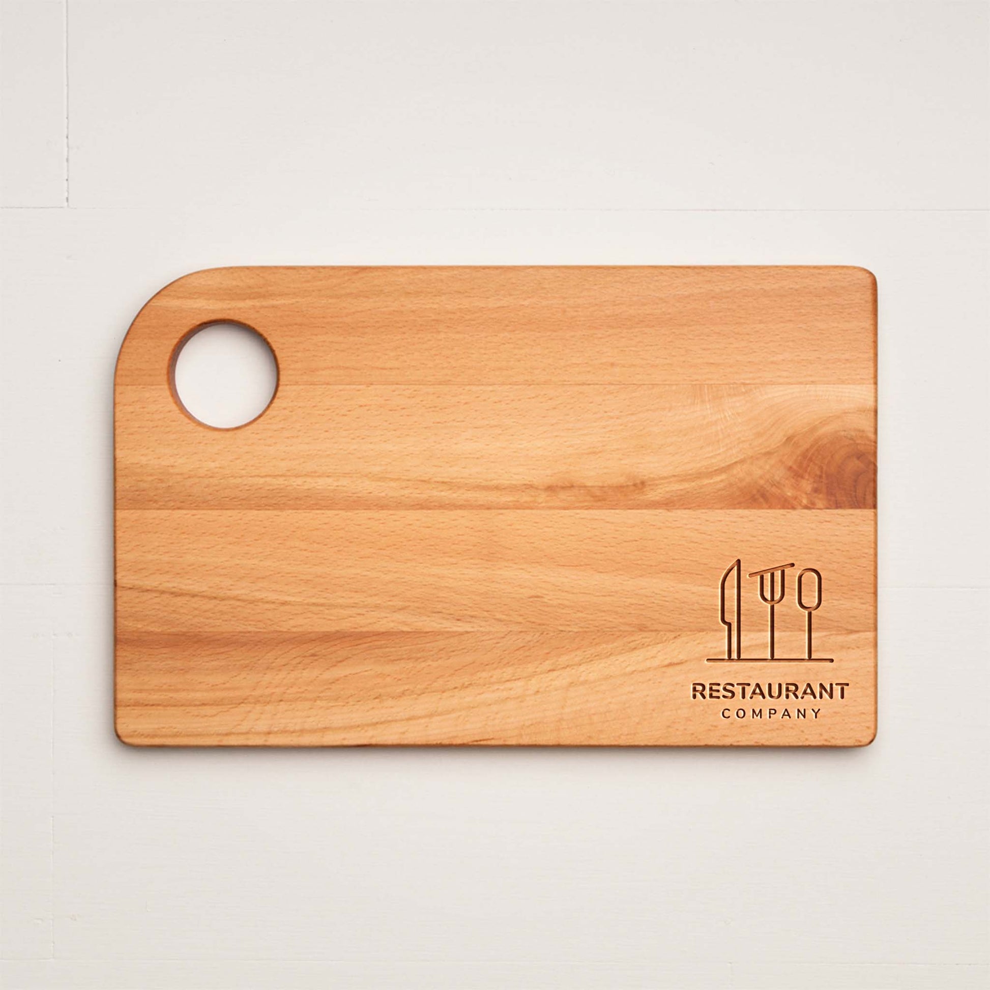 Wooden cutting board with a logo and text on a light background
