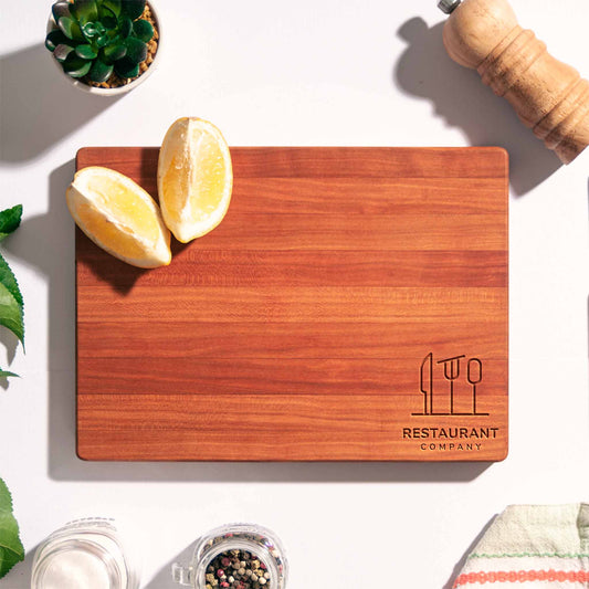 Rectangular cherry wood cutting board with CNC engraved restaurant logo — handmade, food-safe cutting board.
