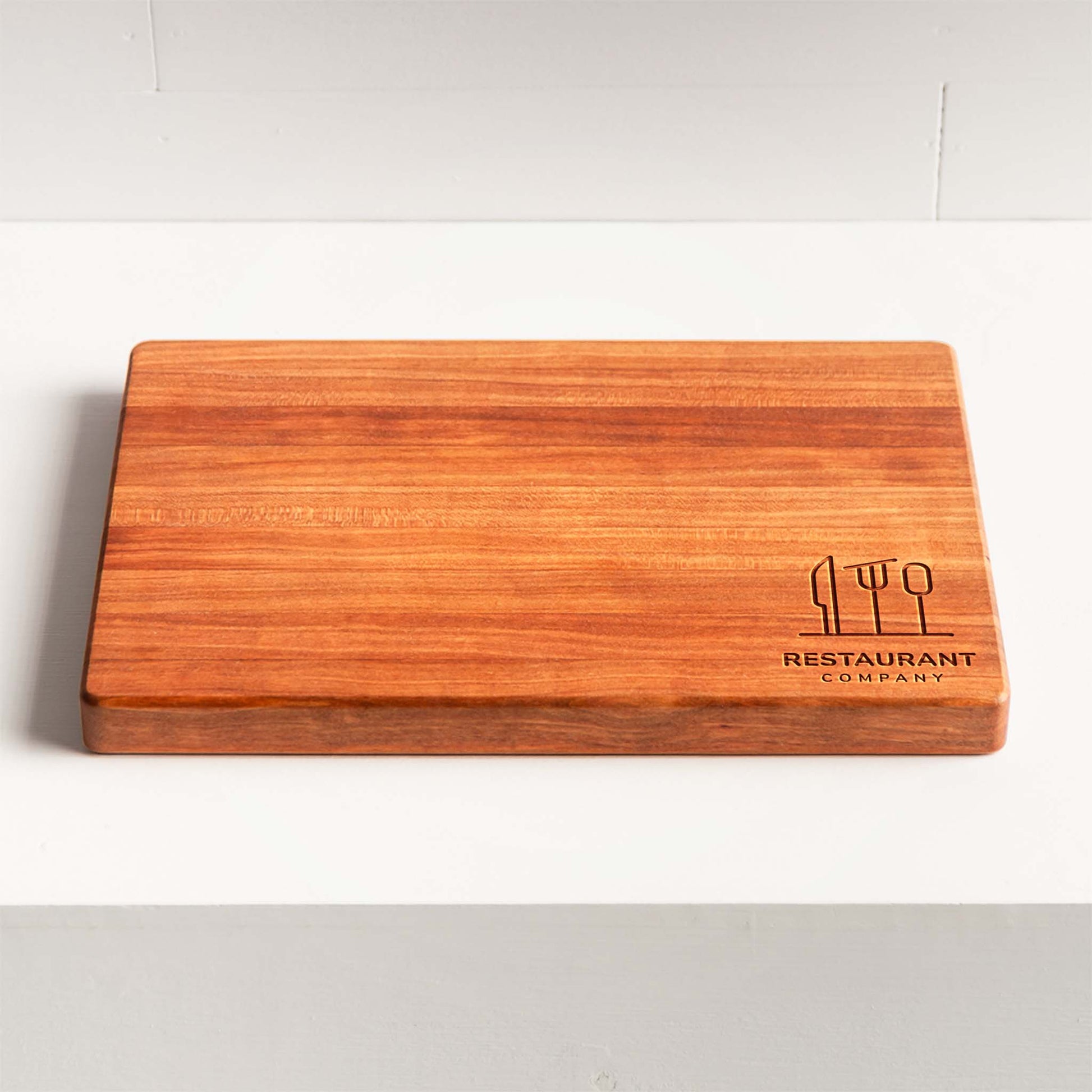 Wooden cutting board with 'Restaurant Company' logo on a white background