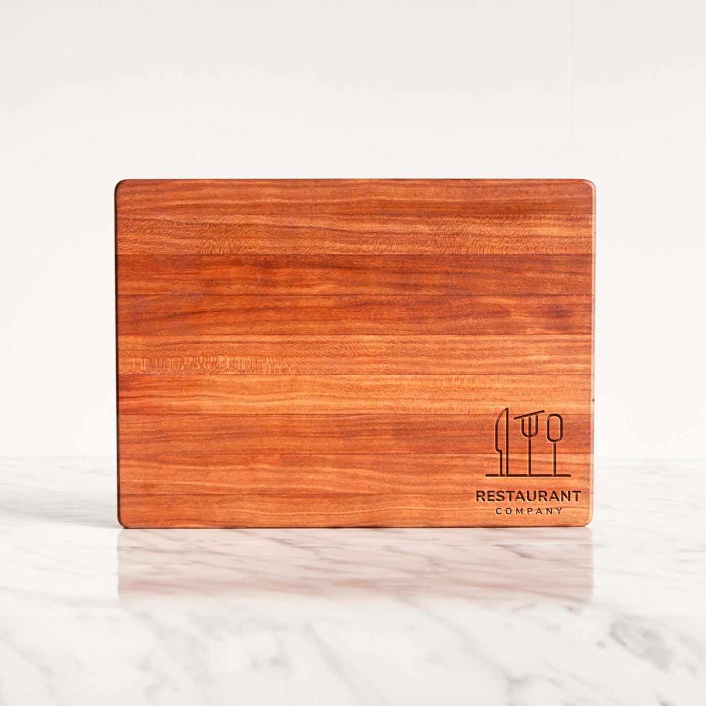 Wooden cutting board with 'Restaurant Company' logo on a white surface