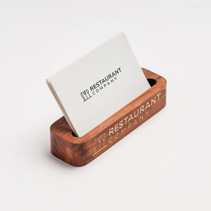 Wooden business card holder with a white card displaying 'Restaurant Company' on a white background