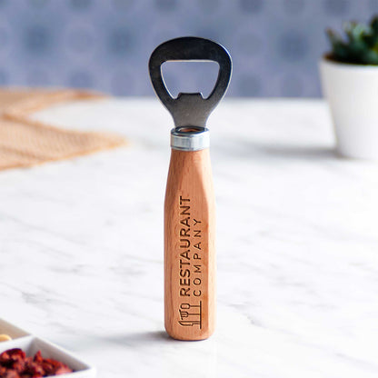 Wooden bottle opener with 'Restaurant Company' branding on a white surface.