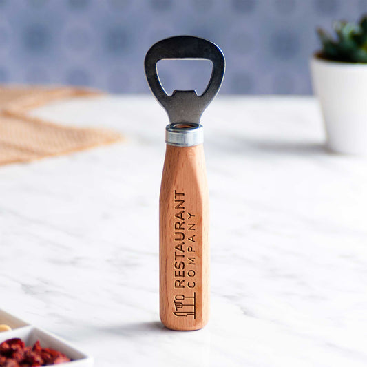 Wooden bottle opener with 'Restaurant Company' branding on a white surface.