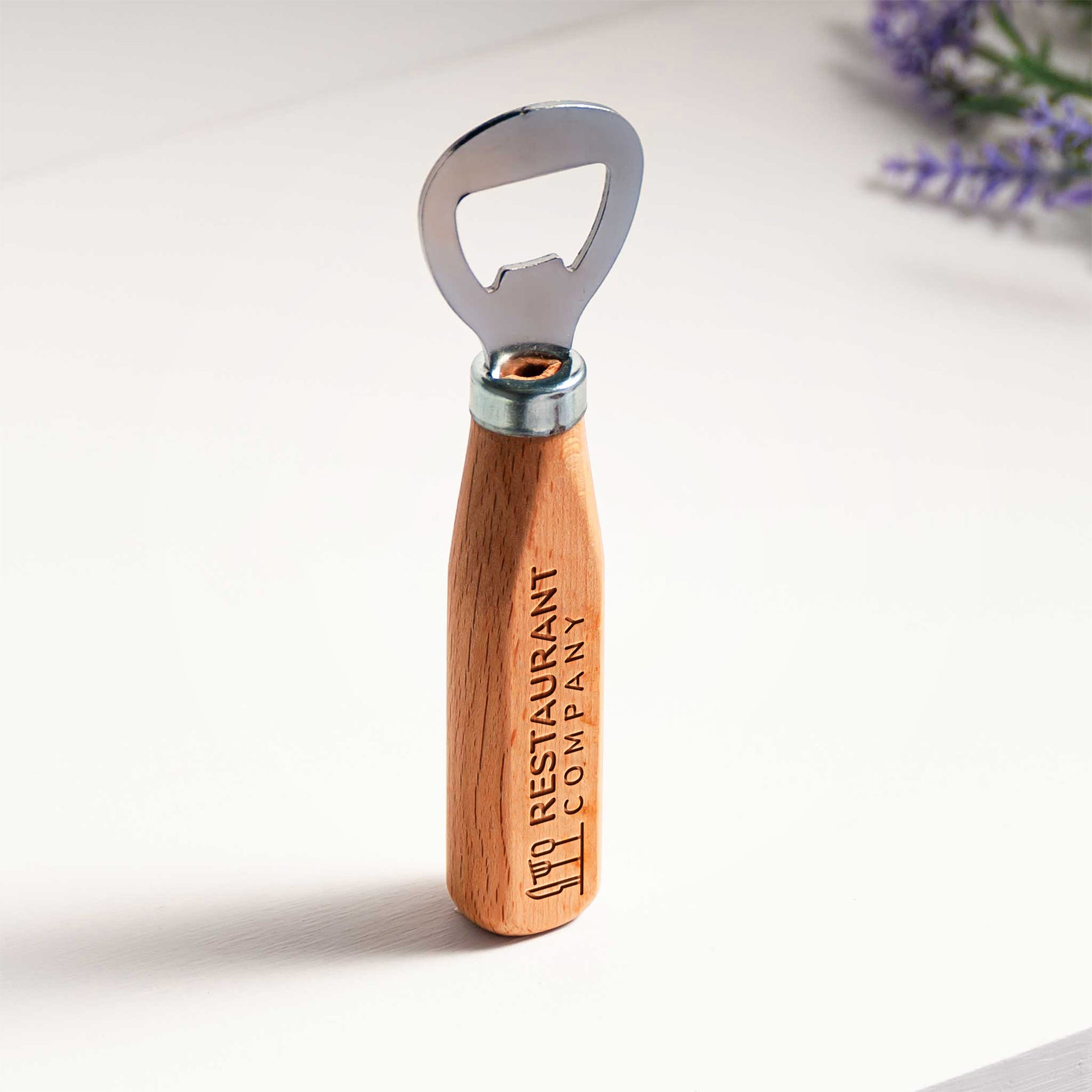 Wooden bottle opener with metal cap on a white background