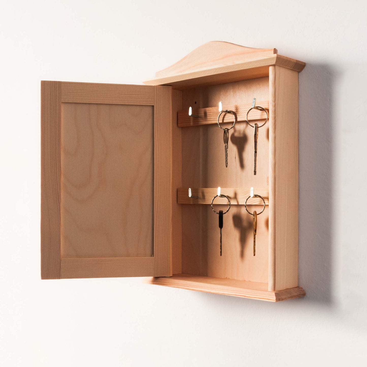 Wooden key rack with personalized engraving, perfect for entryways.