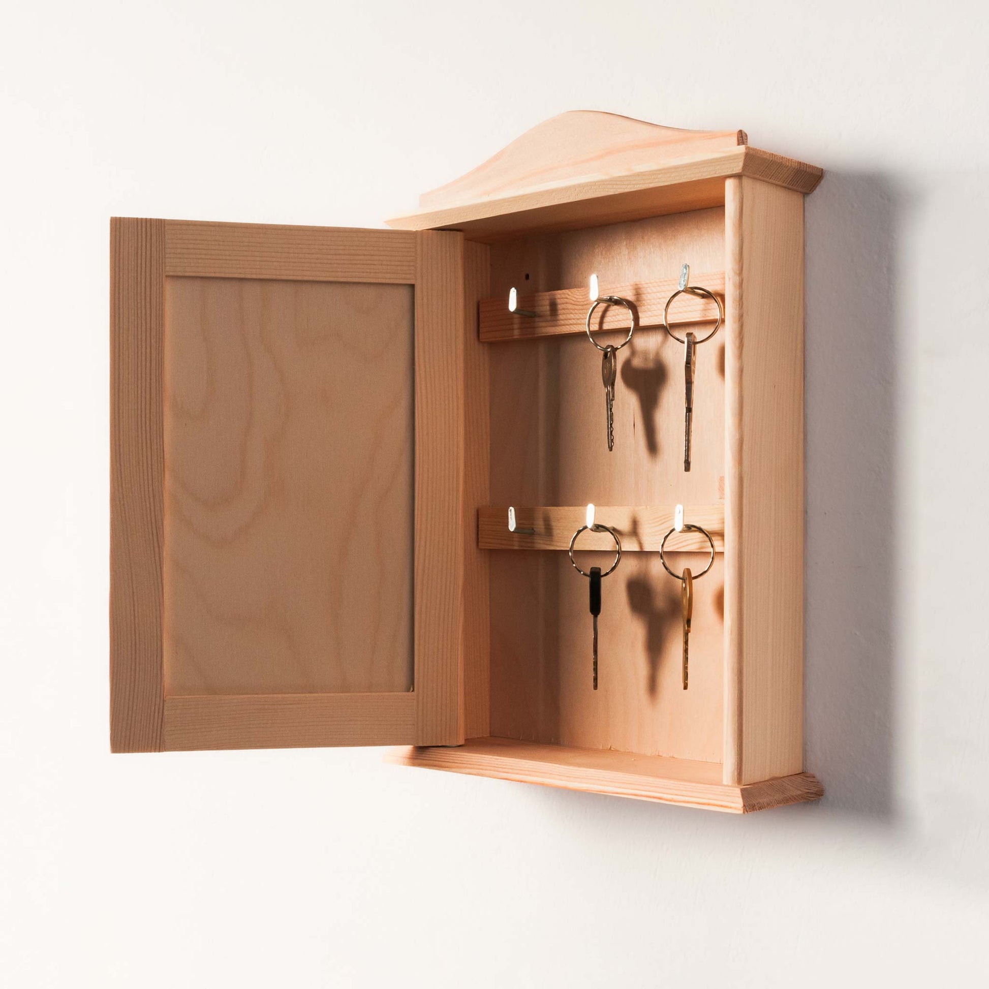 Wooden key rack with personalized engraving, perfect for entryways.