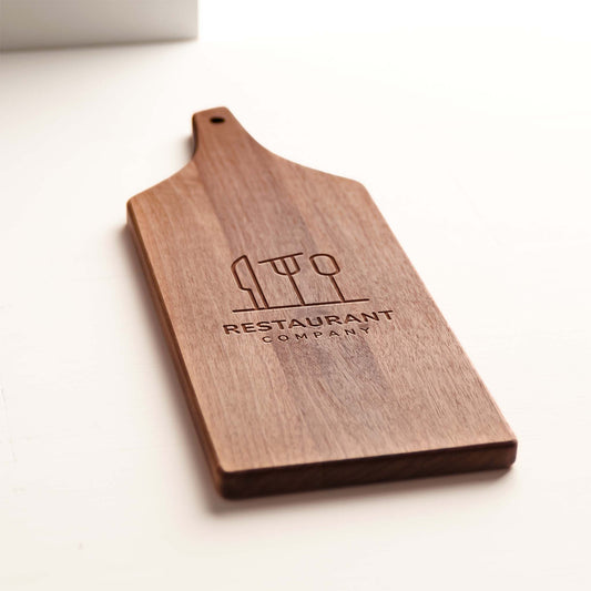 Close-up walnut grain and custom logo engraving on cheese board