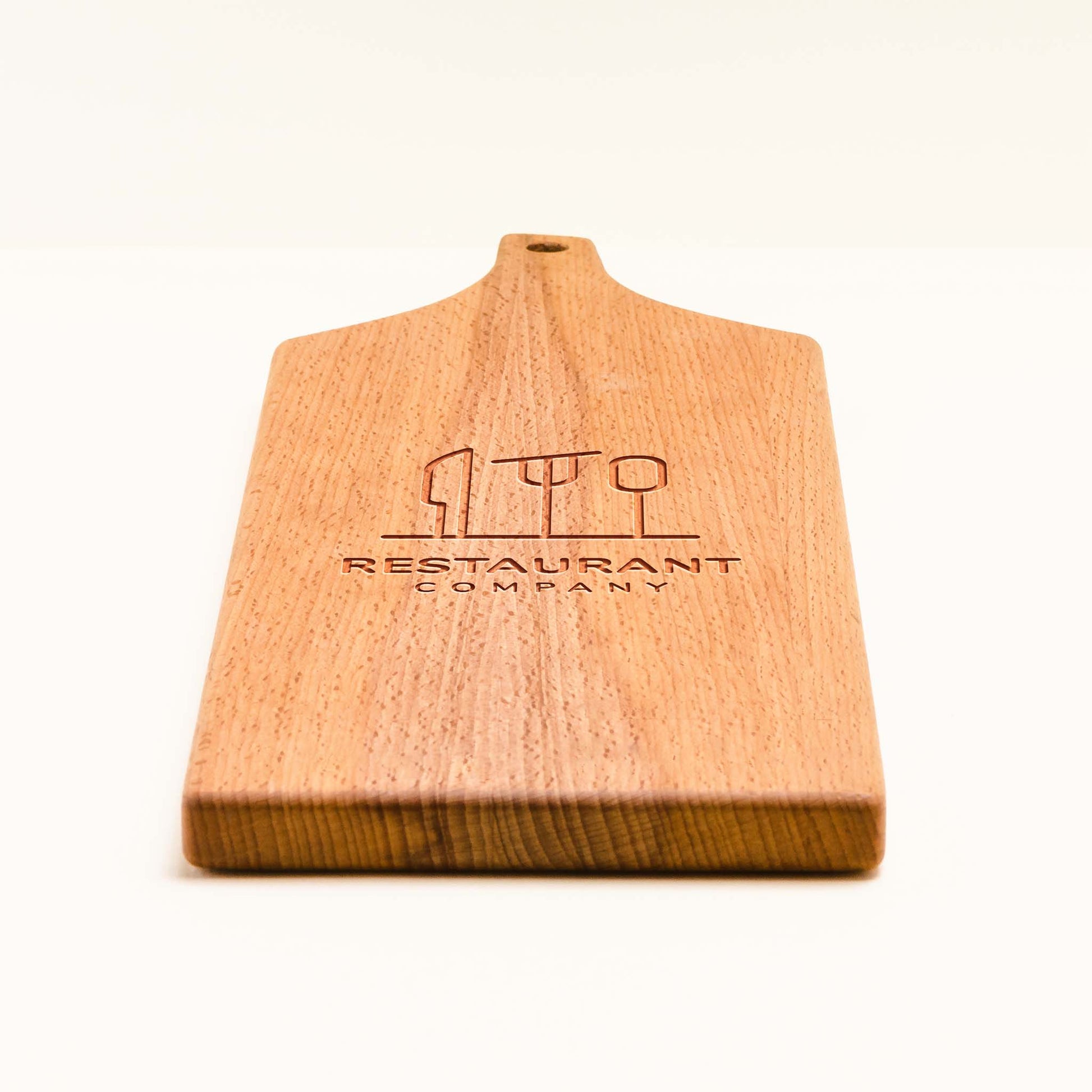 Wooden cutting board with engraved text on a white background