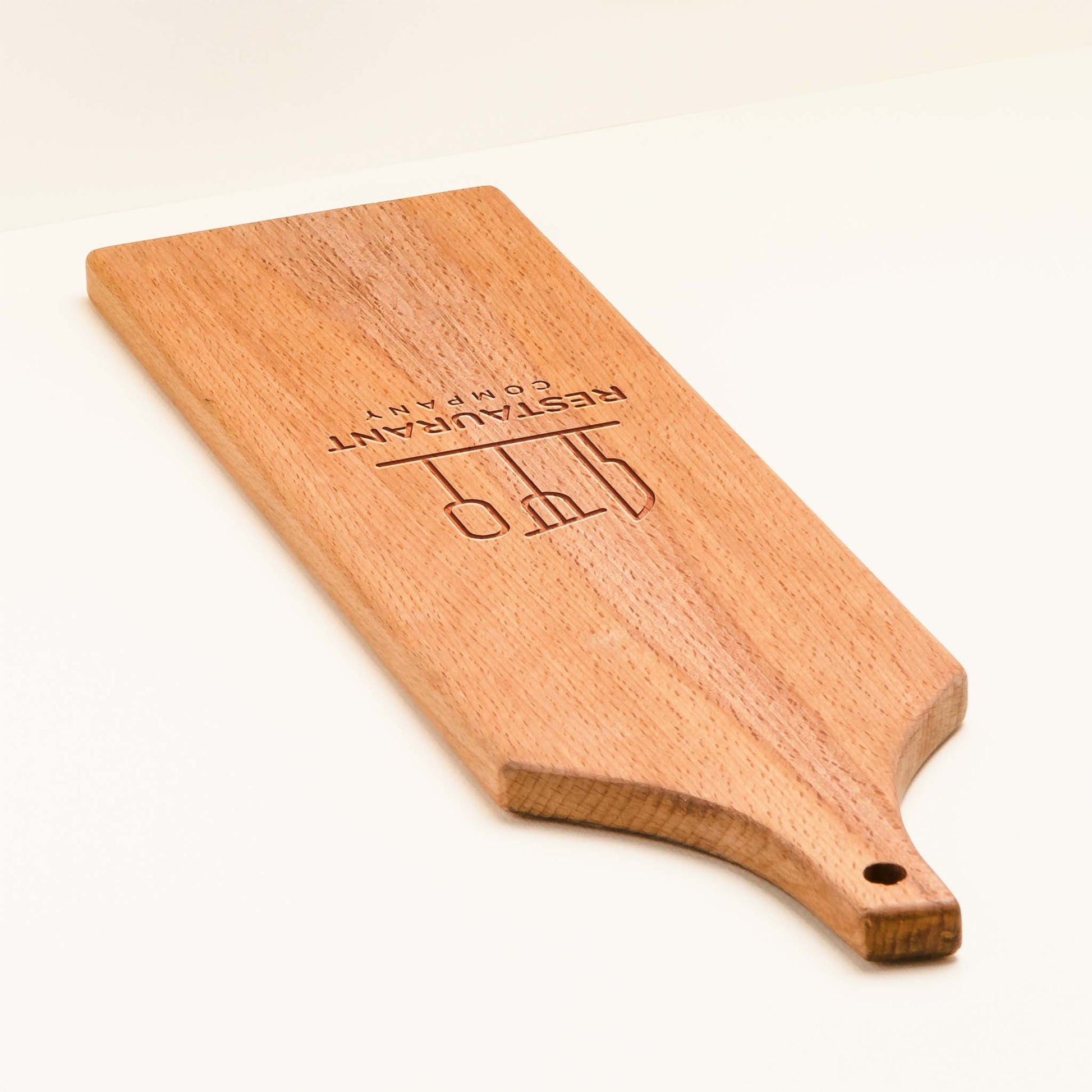 Wooden paddle with 'Company' branding on a white background