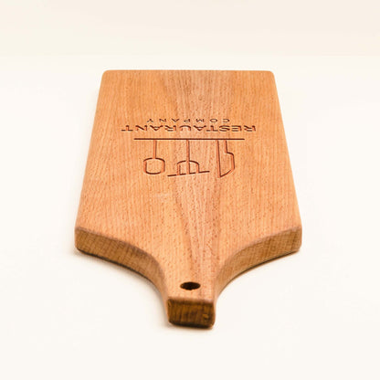 Wooden paddle with 'Restaurant Company' branding on a white background