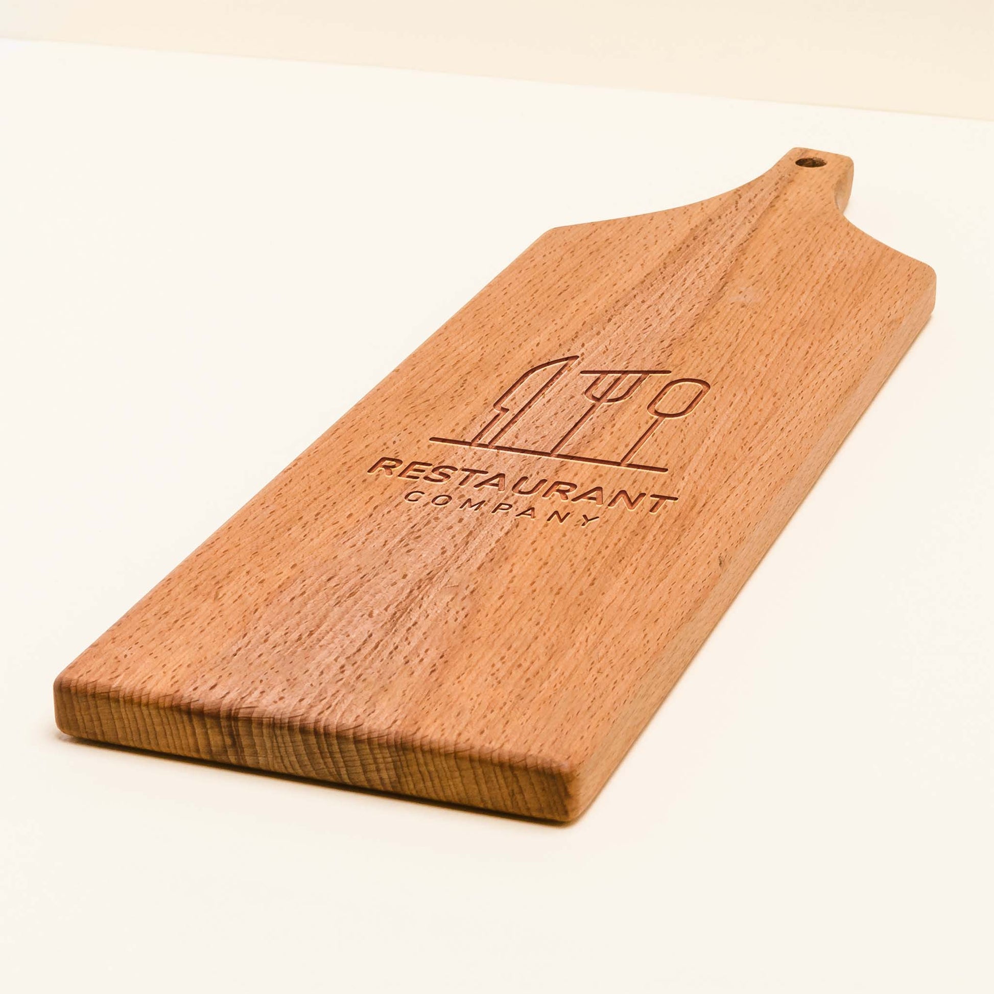 Wooden cutting board with 'Restaurant Company' logo on a white background