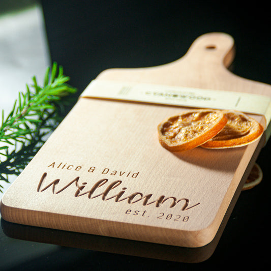 Handmade beech wood charcuterie board with personalized family name engraving