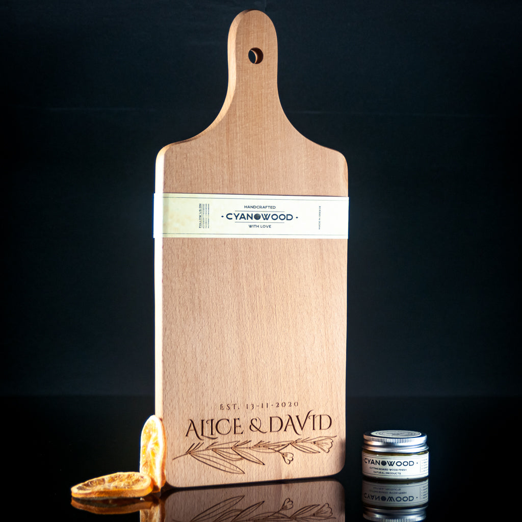 Personalized wooden charcuterie board with leaf branch design and name engraving